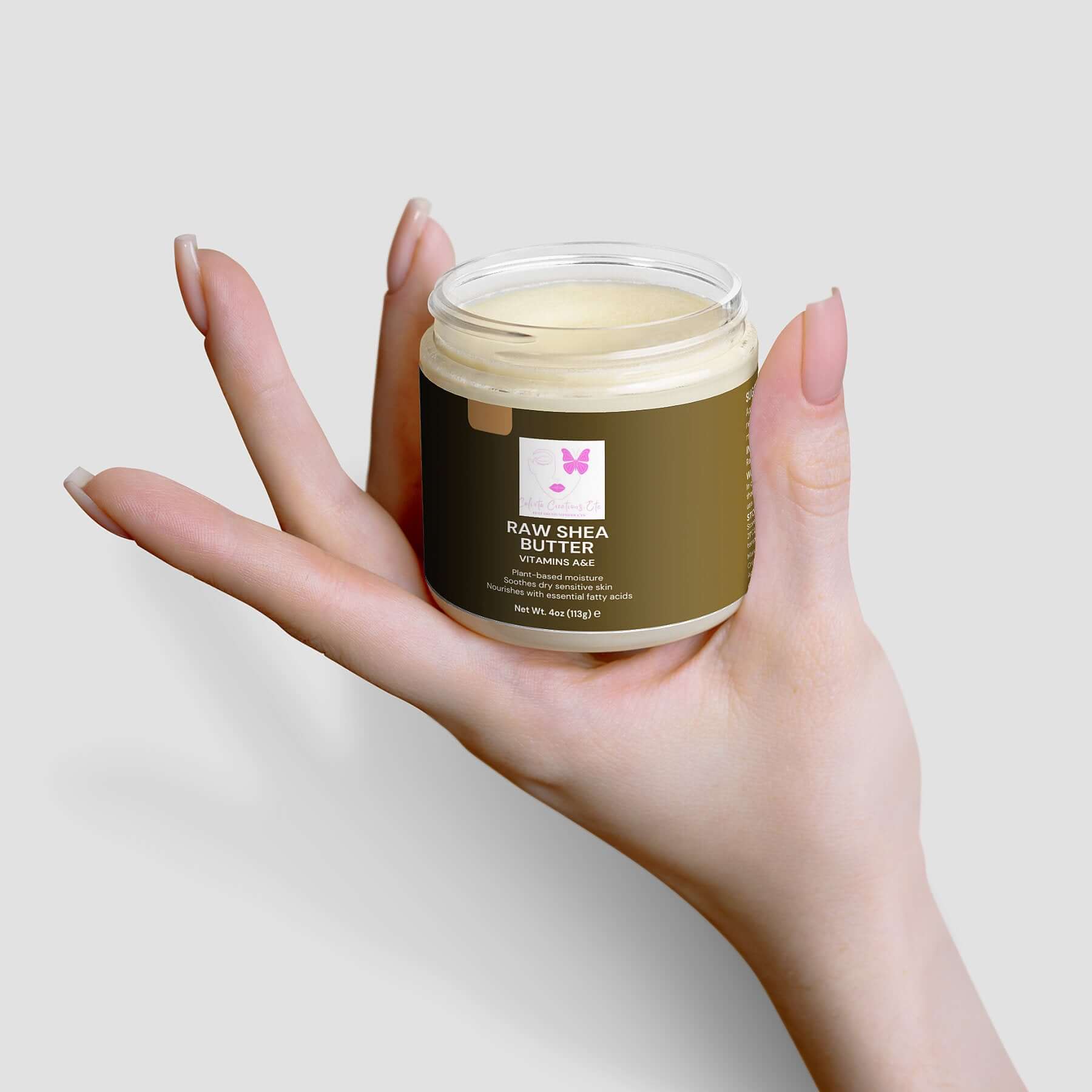 Hand holding a jar of Organic Raw Shea Butter, a 100% vegan and cruelty-free, deeply moisturizing and plant-based skincare essential.