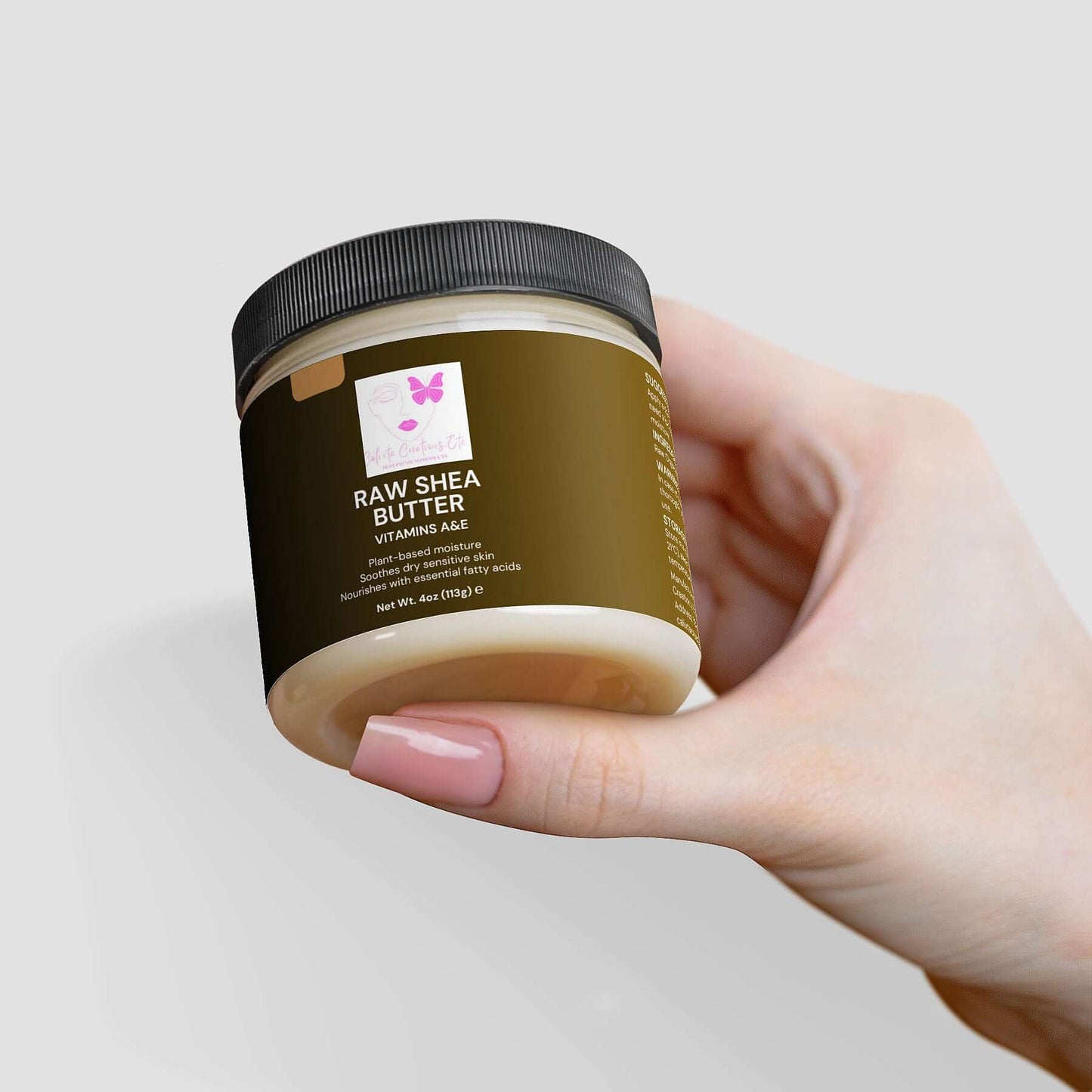 Hand holding a jar of Organic Raw Shea Butter, a plant-based, deeply moisturizing skincare essential.